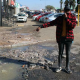 Coat corner’s manager Lawrence Magabane poiting out the sewerage leakage at the front of their shop.