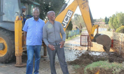 Selby Hlongwane and and Themba Gonwela outside their complex as the pipe is being repaired. Photo: Jarryd Westerdale